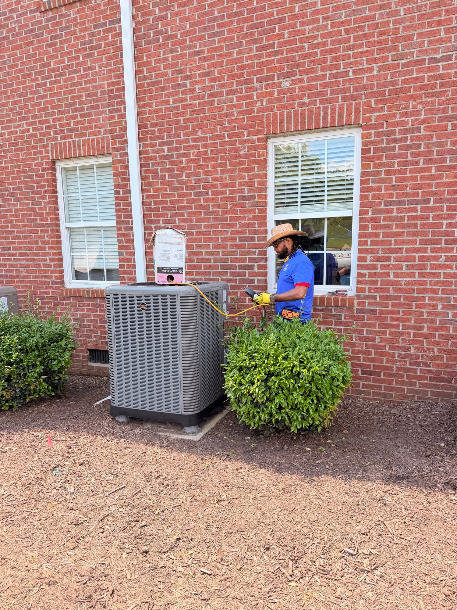 Technician diagnosing an air conditioning system for Restore Heating & Cooling